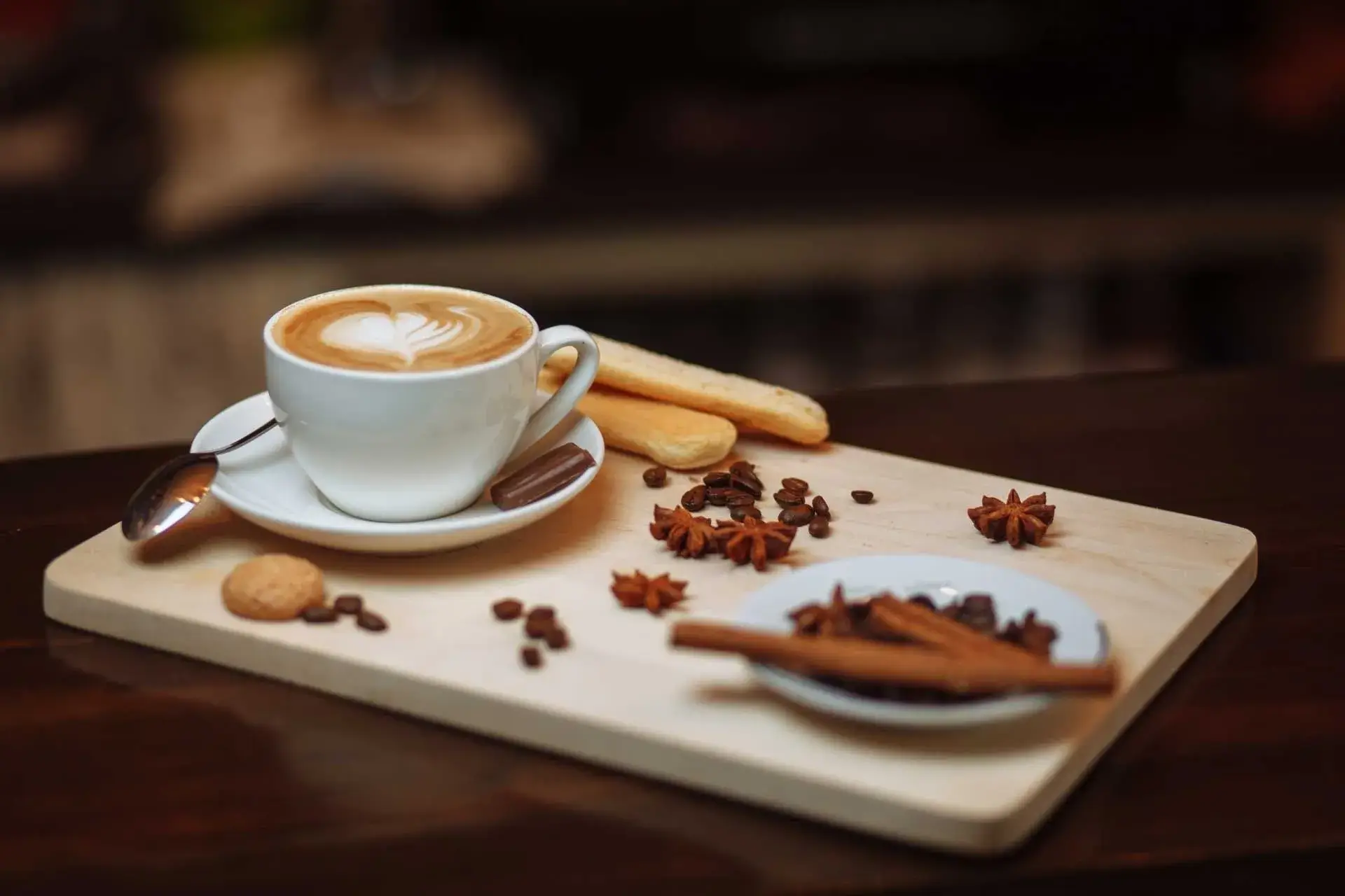 A cup of coffee and some cookies on a tray
